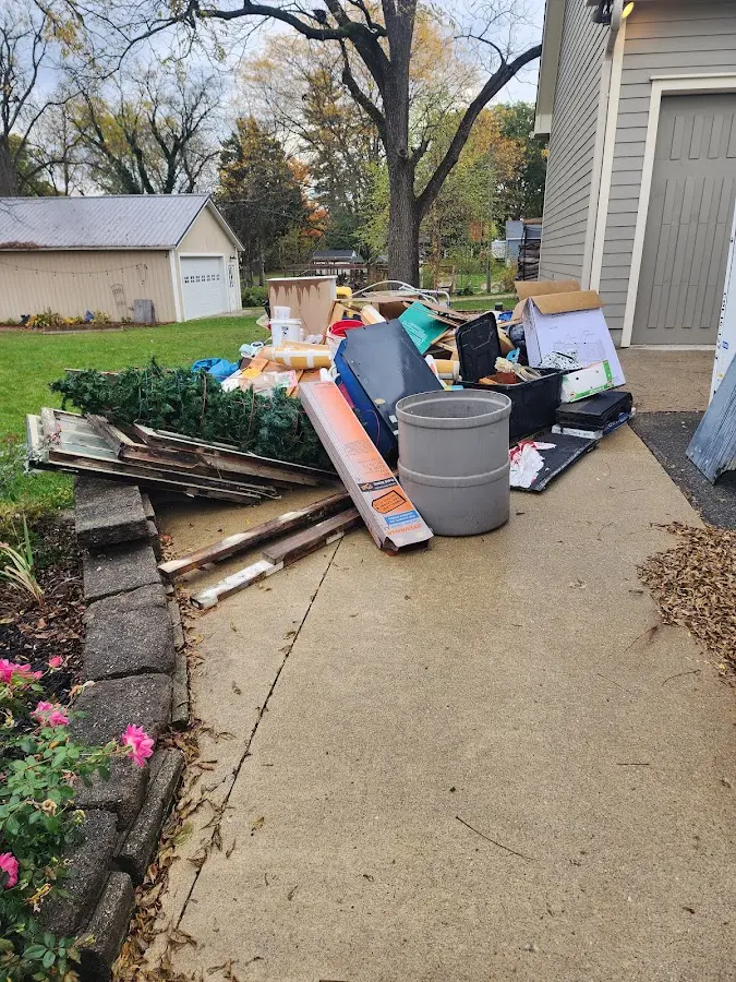 Dumpster being loaded with debris for Estate Cleanout Dumpster Rental in Upper Makefield